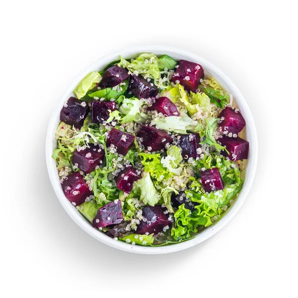 Beetroot, quinoa and mixed leaf salad in a white bowl